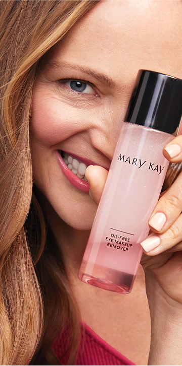 Blonde model holding Mary Kay Oil Free Eye Makeup Remover over her eye